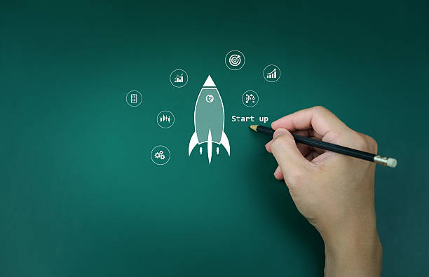 istock Business startup, businessman show rocket launch A hand draws a rocket on a chalkboard, surrounded representing business symbolizing startup innovation. growth and investment growth, success, goals 2234240860