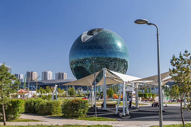 Astana, Kazakhstan (Qazaqstan), 21 jule 2025 - International Center for Artificial Intelligence in Astana. A spherical building on the territory of the former EXPO-2017. A park with a children's area and modern canopies for shade.