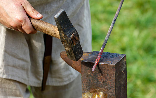 istock Man is hammering a piece of metal 2234243909