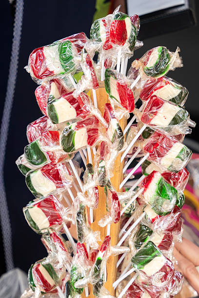 A bunch of colorful lollipops are displayed on a wooden stick, Mexican independence day ornaments