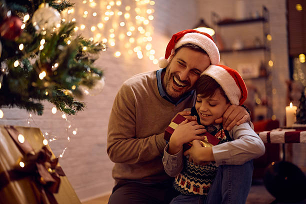 istock Joyful father surprising his son with a gift on Christmas. 2234246566