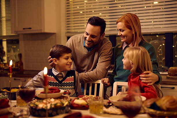 istock Happy family talking while gathering in dining room on Christmas Eve. 2234246814