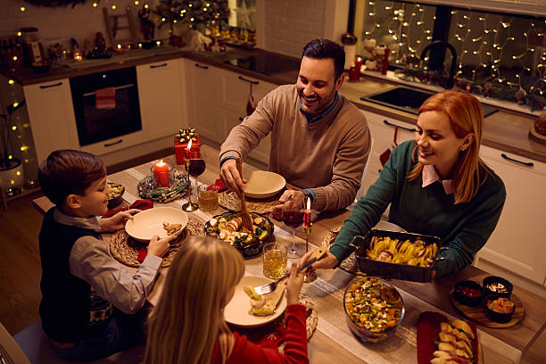 istock Happy family having a meal at dining table on Christmas. 2234246914
