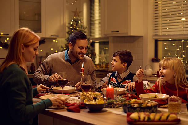 istock Happy boy and his father communicating during Christmas family dinner. 2234247012