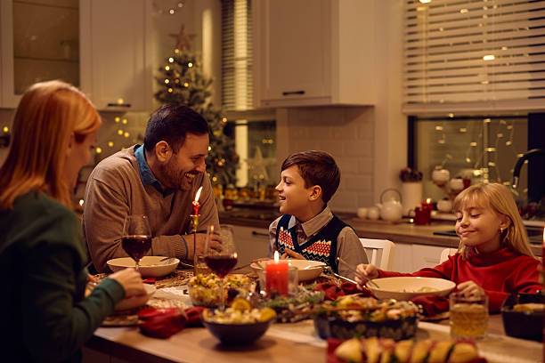 istock Happy father and son talking during family dinner on Christmas. 2234247049