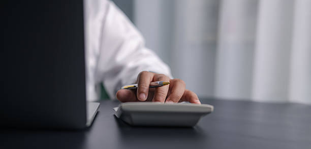 istock Businessman Using Calculator and Laptop for Accounting and Financial Planning 2234247108