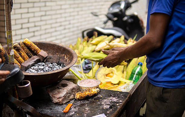 istock Indian man selling roasted corn on street. 2234247936