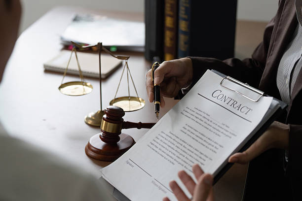 istock Contract Signing. Lawyer presenting contract to client with gavel on desk. 2234247964