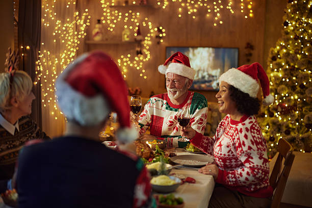 istock Happy senior couples talking on Christmas lunch in dining room. 2234249210