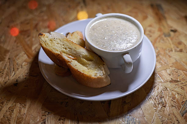 Bowl of mushroom soup served with toasted bread