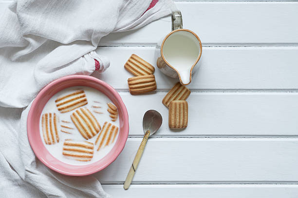 Baby biscuit with milk in white bowl