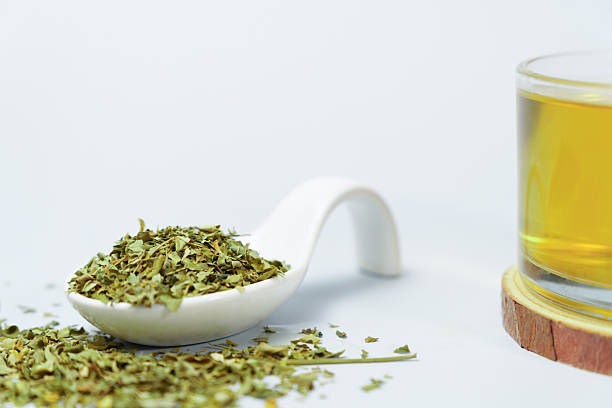 istock Moringa oleifera dried leaves with herbal tea infusion on white background 2234253350