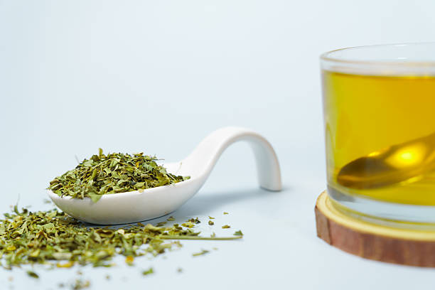 istock Moringa oleifera infusion with dried leaves and spoon resting on light blue background 2234253354