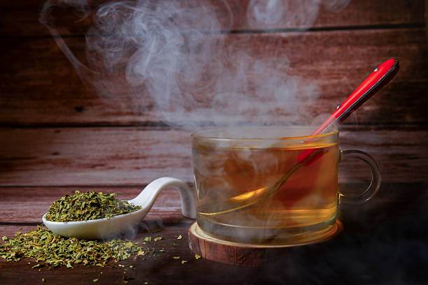 istock Steaming moringa oleifera tea with dried leaves on rustic wooden table 2234253355