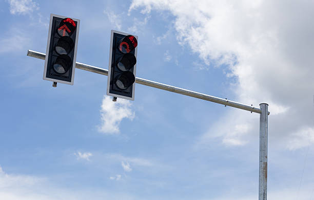 istock Red light traffic signal pole with bright sky background 2234255564