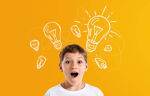 istock Surprised boy with creative lightbulb sketches symbolizing ideas 2234255595