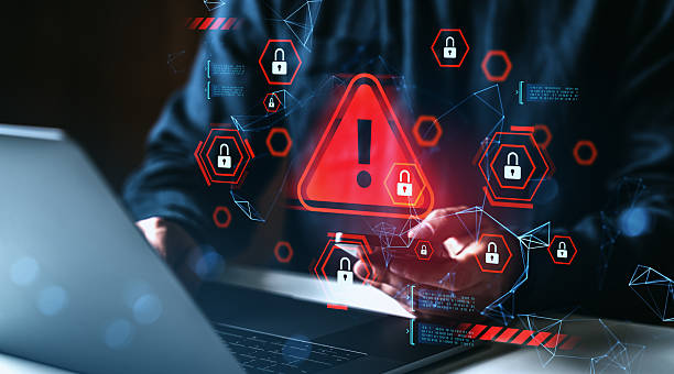 istock Cybersecurity breach warning with red alert symbol and open padlocks over digital interface and person using laptop, concept of data protection failure. 2234255639
