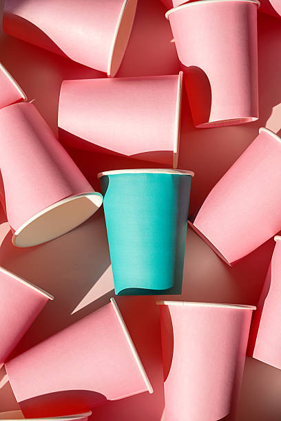 istock Teal paper cup standing out among many pink cups. 2234256057
