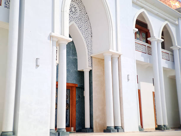 istock Facade of a building featuring white arches, columns, and intricate geometric patterns in daylight. 2234257729