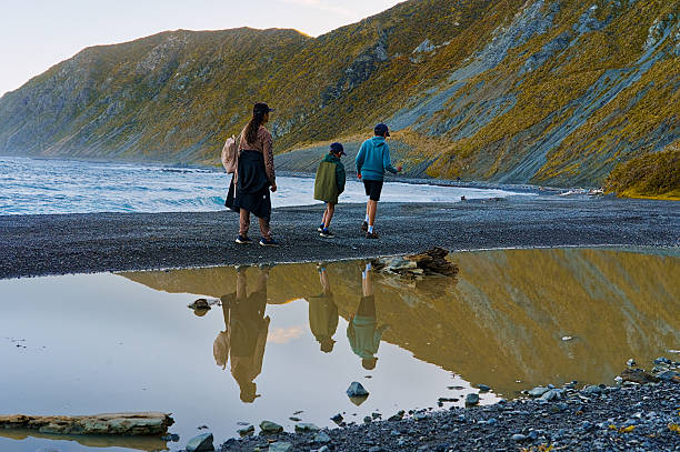 istock Family walk at the red rocks beach 2234260104