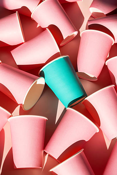 istock Teal cup standing out among many pink paper cups. 2234260360