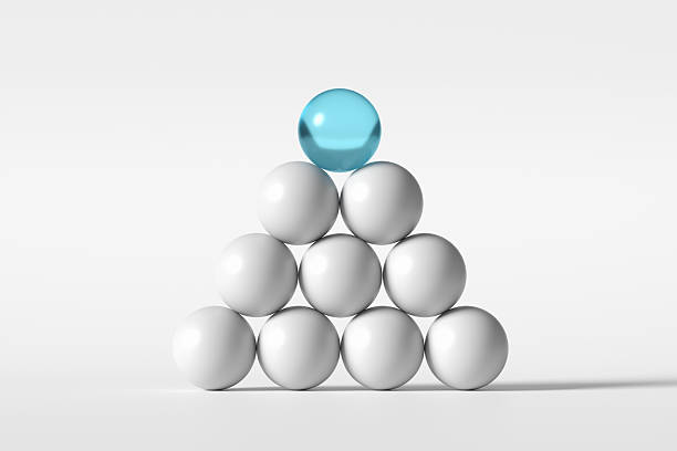 istock Blue sphere leading white spheres forming a pyramid 2234261328