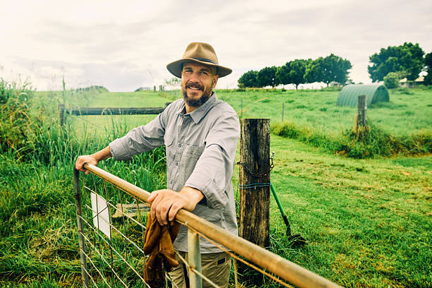 istock Australian farmer smiling at the ranch leaning on a fence 2234262155