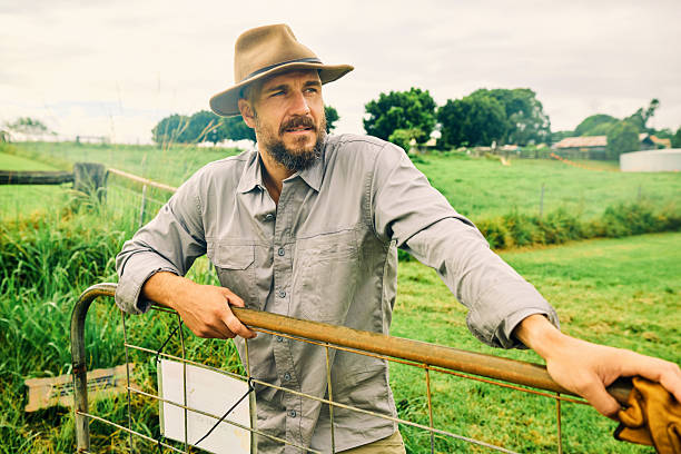 istock Australian farmer smiling at the ranch leaning on a fence 2234262196