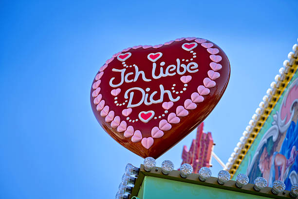A vibrant heart-shaped gingerbread sign with the text