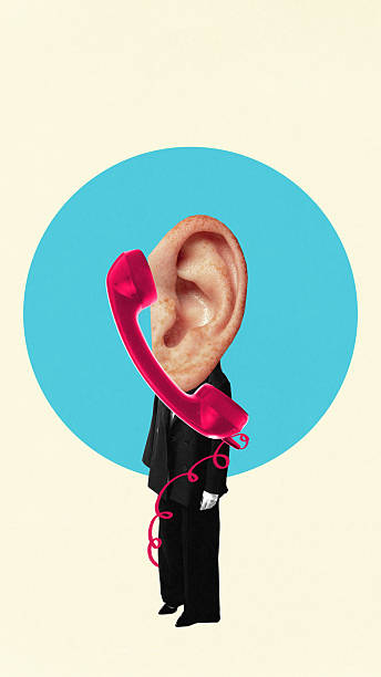 istock Creative collage of oversized human ear with red telephone handset replacing head on beige background 2234267382