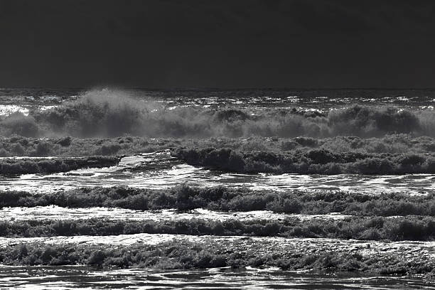 istock Dramatic black and white waves crash against rocky shores under a moody sky 2234267428