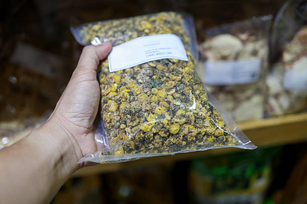 istock Hand holding packed dried chamomile flowers in plastic bag 2234269621