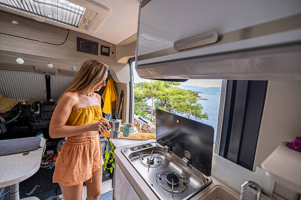 istock Woman Making Coffee in Camper Van by Sea 2234269784