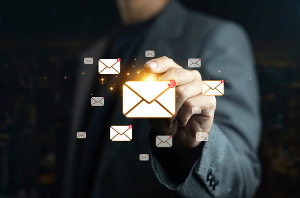 istock Businessman hand touching glowing email icons with notification, digital communication concept for online messaging, new mail, business marketing, and modern technology connection. 2234269797
