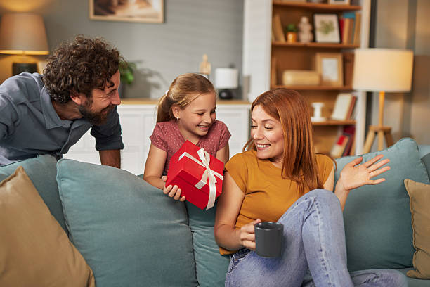 istock Daughter surprising her mother with a gift at home 2234269997