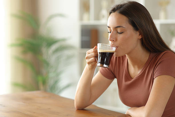 istock Woman drinking coffee in a wooden table at home 2234270079