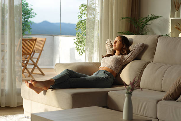 istock Woman relaxing at home on a chaise longue sofa 2234270229