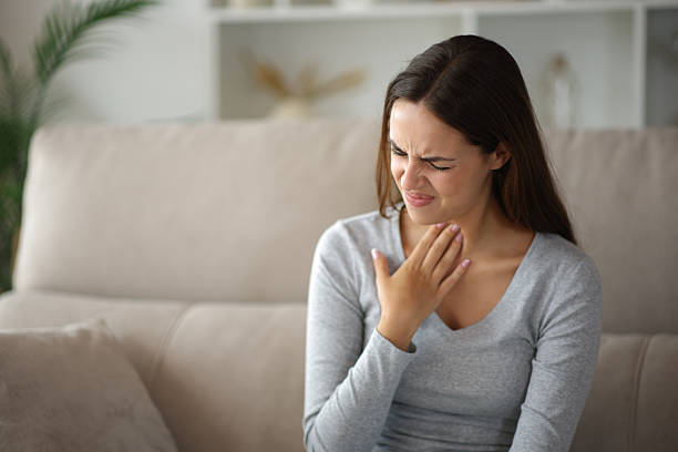 istock Woman suffering throat ache complaining at home 2234270313