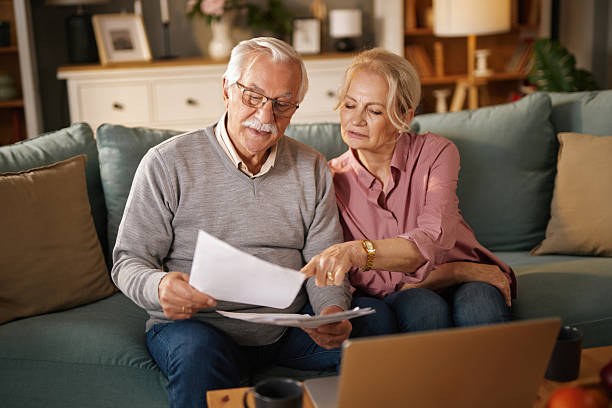 istock Senior couple reading documents and planning retirement at home 2234270923