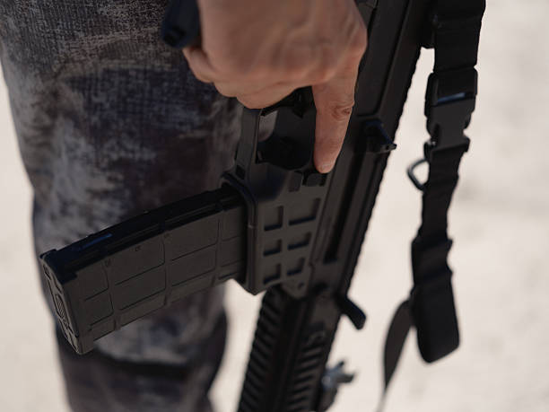 istock Soldier Hand holding a Rifle Magazine 2234271251