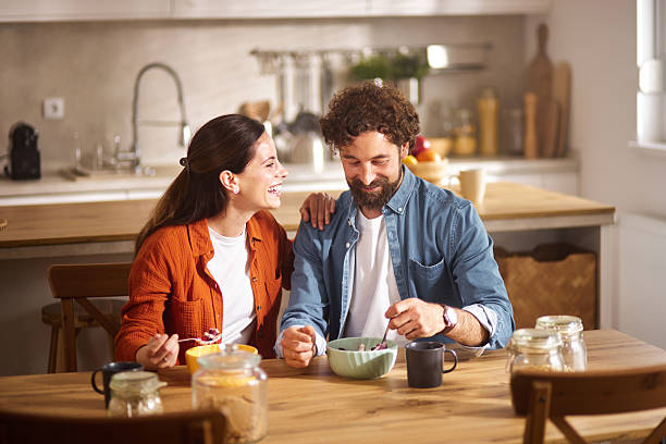 istock Happy couple enjoying breakfast together in their modern kitchen 2234271667