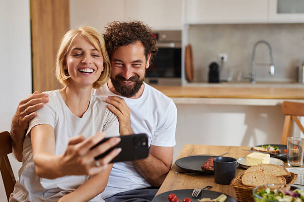 istock Couple enjoying a joyful moment while taking a selfie at breakfast time in a 2234272590