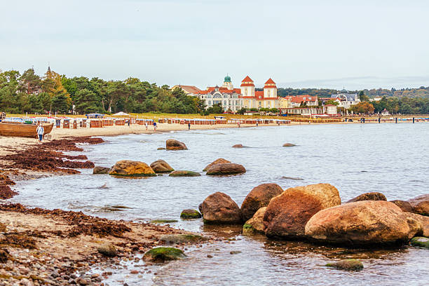 Beach and casino of Baltic Sea resort Binz, Ruegen island, rocks in foreground
