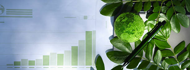 istock Eco-friendly business concept with green earth model, laptop, leaves, and analytics charts. Symbolizes sustainability, green innovation, and environmental responsibility in modern workspaces. 2234276640