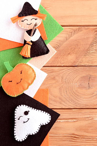 istock Halloween cute felt ornaments. Halloween small witch with broom, pumpkin head, ghost crafts, colored felt pieces 2234278868
