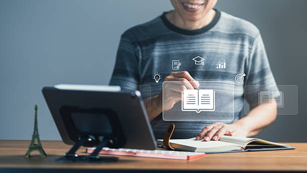 istock Man Engaging in Online Learning with Digital Book and Education Icons 2234279461
