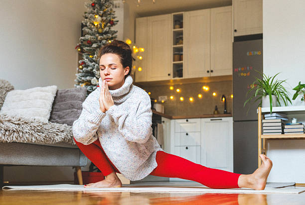 istock Woman at home practicing yoga exercise while Christmas holidays. 2234280054