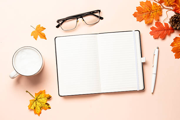 istock Autumn workspace. Notebook, cup of coffee and yellow leaves. 2234282641