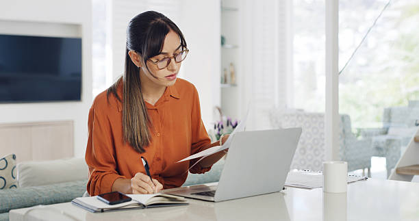 istock Remote work from home, laptop and woman with documents, schedule and research for article. Person, copywriting and journalist with computer, editing and email for feedback, news report and deadline 2234284023