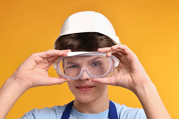 protective glasses lying on kitchen countertops, marking cutting hole for the sink, renovation, copy space